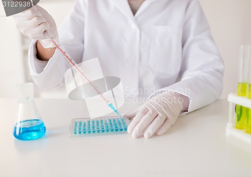 Image of close up of scientist making test in lab