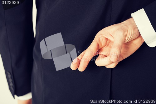 Image of man with crossed fingers