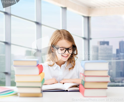 Image of happy student girl reading book at school