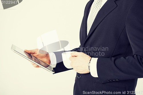 Image of man with tablet pc and cup of coffee