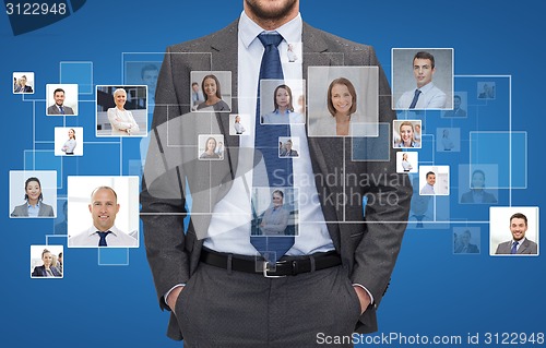 Image of close up of businessman over icons with contacts