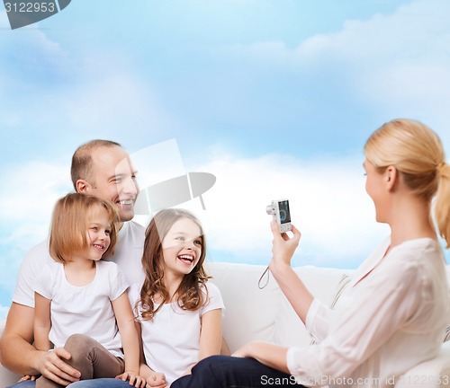 Image of happy family with camera at home