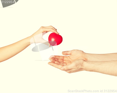 Image of woman and man hands with heart