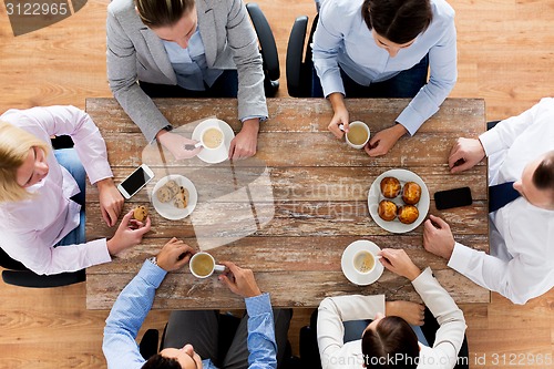 Image of close up of business team drinking coffee on lunch