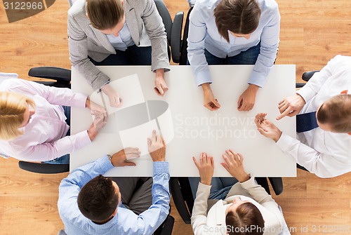 Image of close up of business team sitting at table