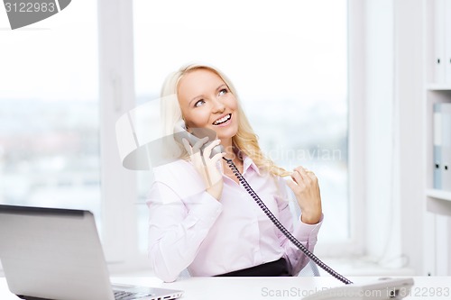 Image of smiling businesswoman or student calling on phone