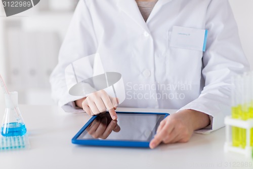 Image of close up of scientist with tablet pc in lab