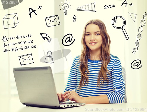 Image of smiling teenage gitl with laptop computer at home