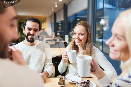 Image of happy friends meeting and drinking tea or coffee