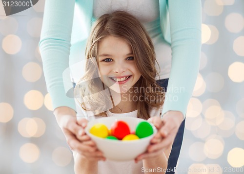 Image of close up of happy family holding easter eggs