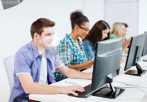 Image of student with computer studying at school