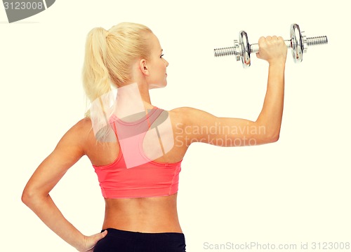 Image of sporty woman with heavy steel dumbbell from back