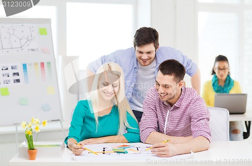 Image of smiling interior designers working in office