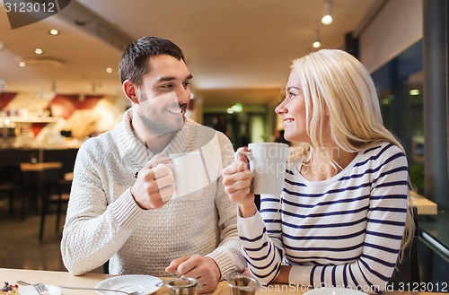 Image of happy couple meeting and drinking tea or coffee