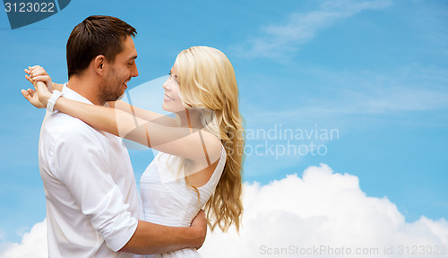 Image of happy couple hugging over blue sky and cloud