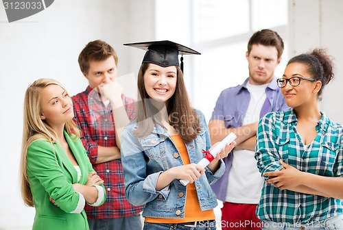 Image of girl in graduation cap with certificate