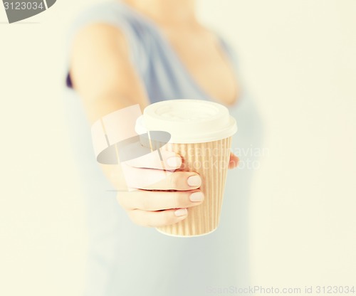 Image of woman hand holding take away coffee cup