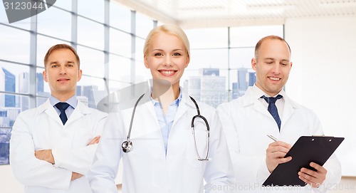 Image of group of smiling doctors with clipboard