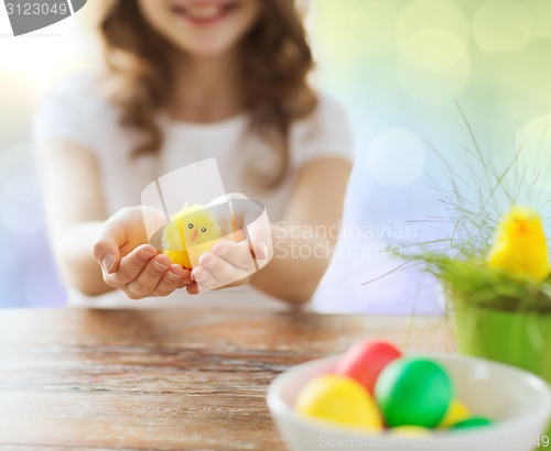 Image of close up of girl holding easter chicken toy