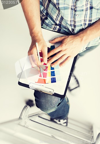 Image of man with color samples for selection