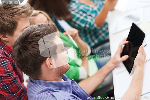 Image of students looking at tablet pc at school