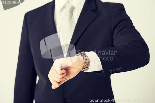 Image of man looking at wristwatch