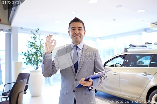 Image of happy man at auto show or car salon