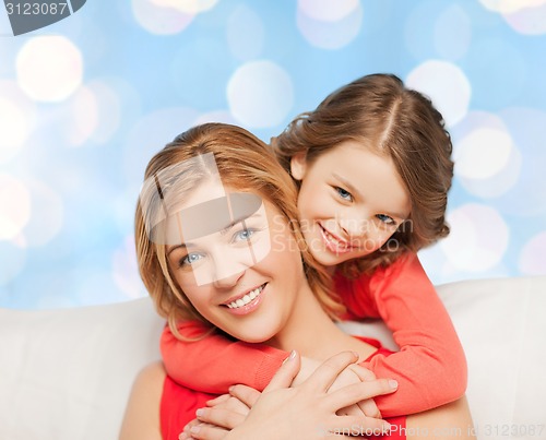 Image of happy mother with daughter hugging and talking