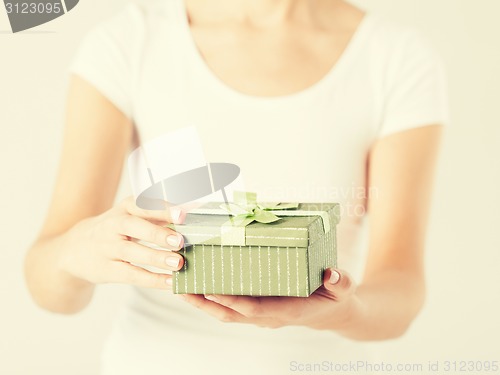 Image of woman hands with gift box