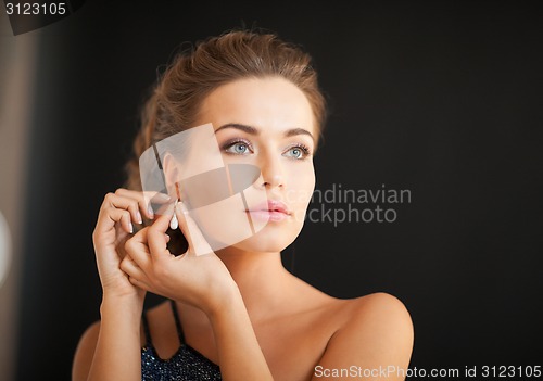 Image of woman with diamond earrings