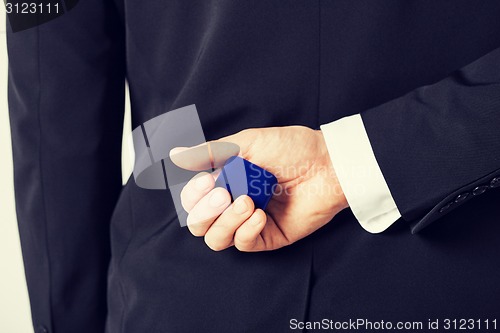 Image of man with gift box in suit