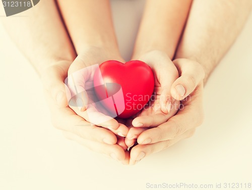 Image of woman and man hands with heart