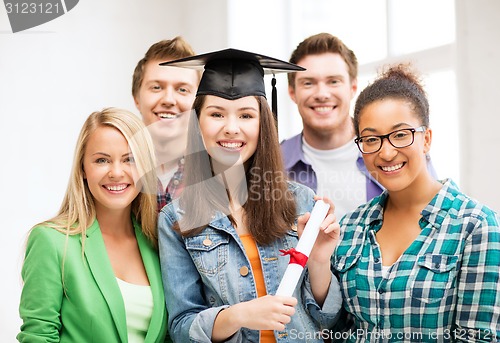 Image of girl in graduation cap with certificate