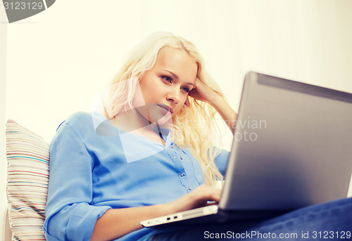 Image of woman with laptop computer at home