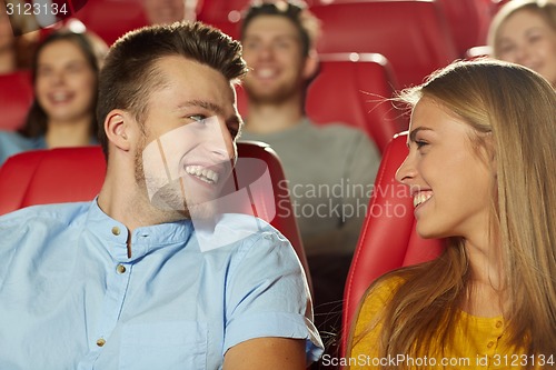 Image of happy friends watching movie in theater