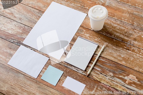 Image of close up of notebook, coffee cup and papers