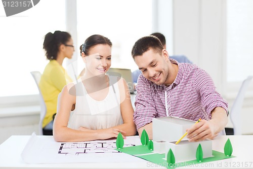 Image of smiling architects working in office