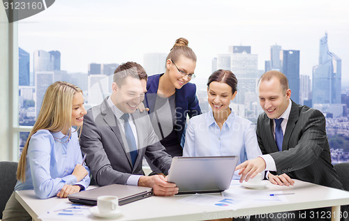 Image of business team with laptop having discussion