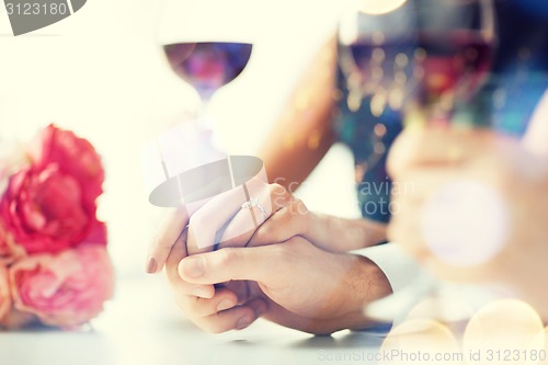 Image of engaged couple with wine glasses