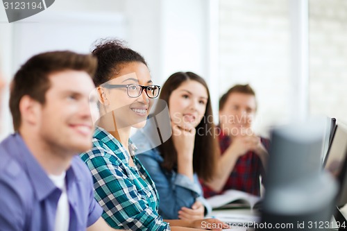 Image of students with computers studying at school