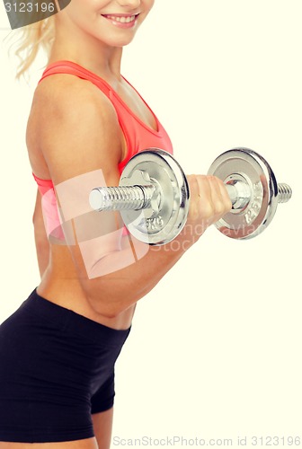 Image of close up of sporty woman with heavy steel dumbbell