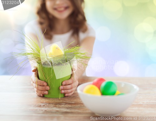 Image of close up of girl holding pot with easter grass