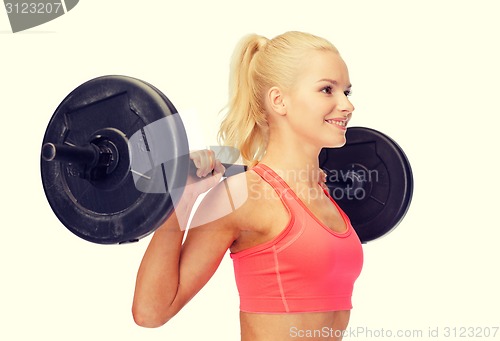 Image of smiling sporty woman exercising with barbell