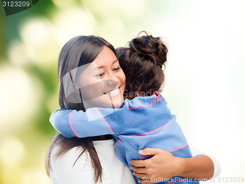 Image of happy mother and daughter hugging