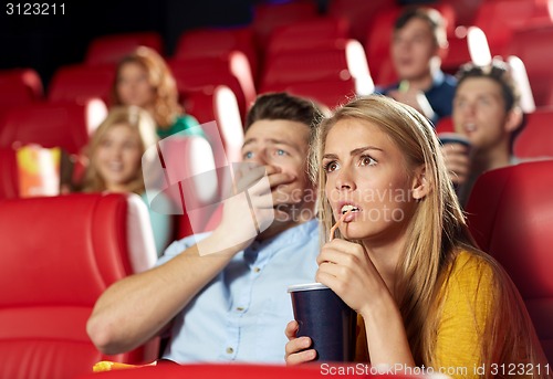 Image of friends watching horror movie in theater
