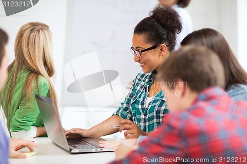 Image of african student girl with laptop at school