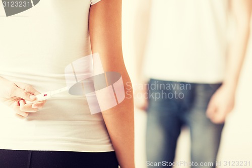 Image of woman hiding pregnancy test