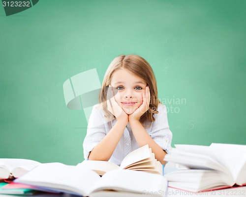 Image of happy student girl with books at school