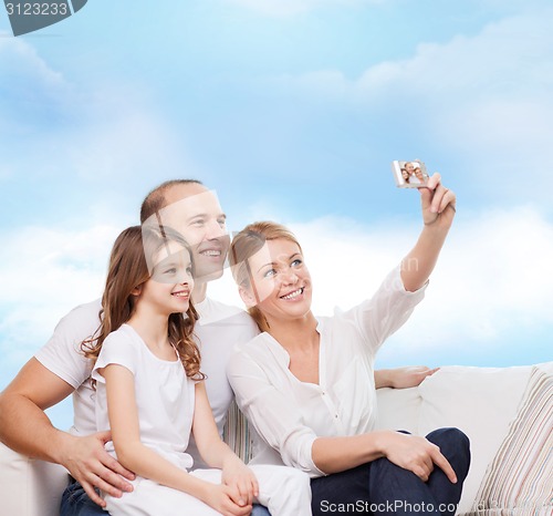 Image of happy family with camera at home