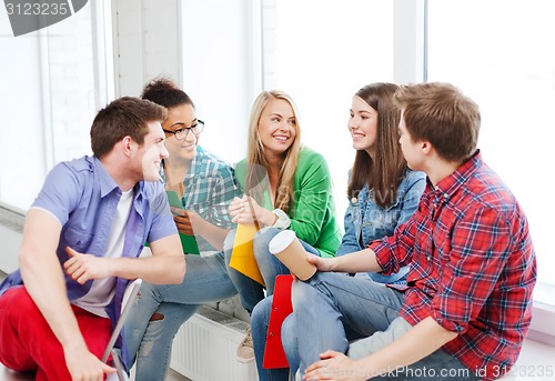 Image of students communicating and laughing at school